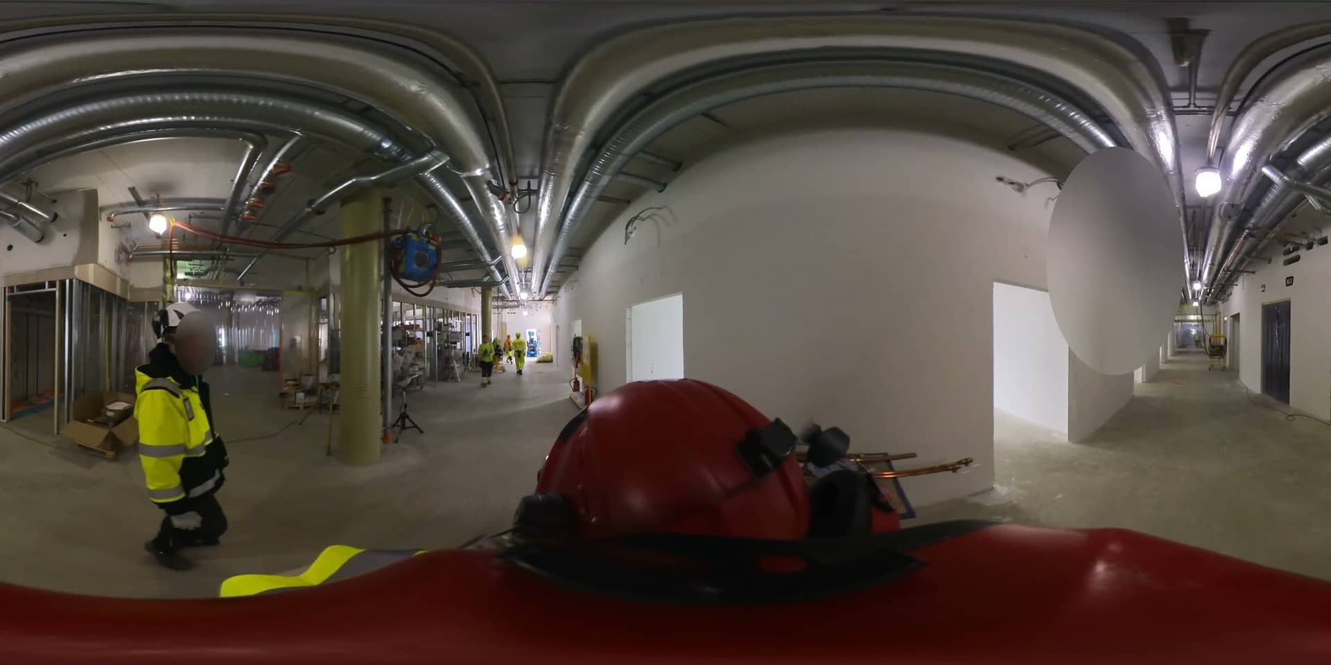 An equirectangular 360° video frame from a building under construction